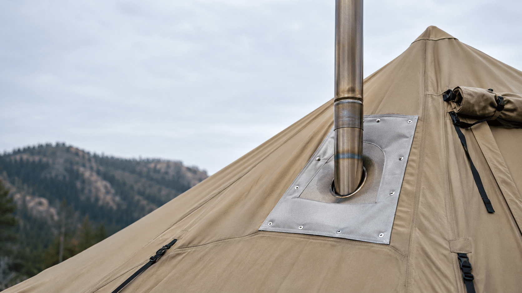 Hot tent stove pipe passing through a reinforced stove jack